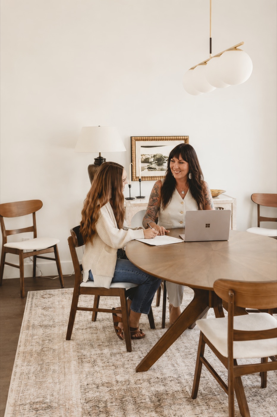 Erica Greye, founder of Restorative Living, seated with a client at a wooden table