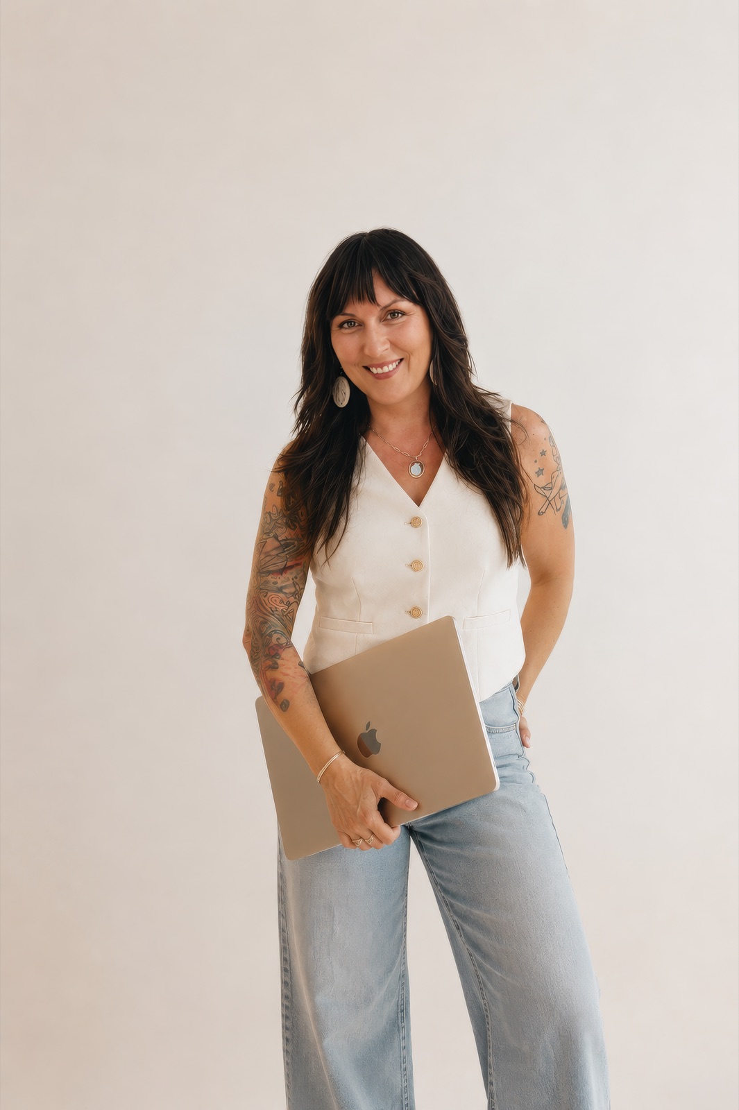 Erica Greye standing, holding a laptop